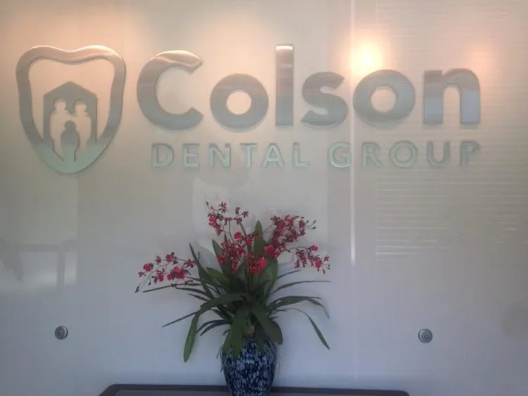 office entrance showing dr's logo and a flower vase